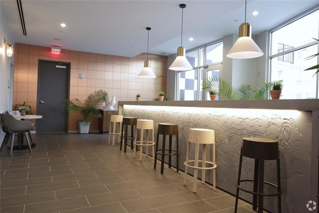 207 13th Street Northeast, Unit S2 Atlanta, GA 30309 - Photo 5 of 46 a large dining space with furniture a chandelier and window