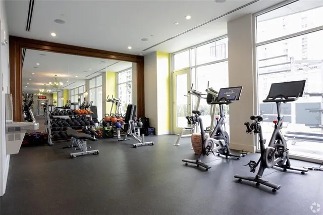 a view of a dining room with furniture a chandelier and wooden floor