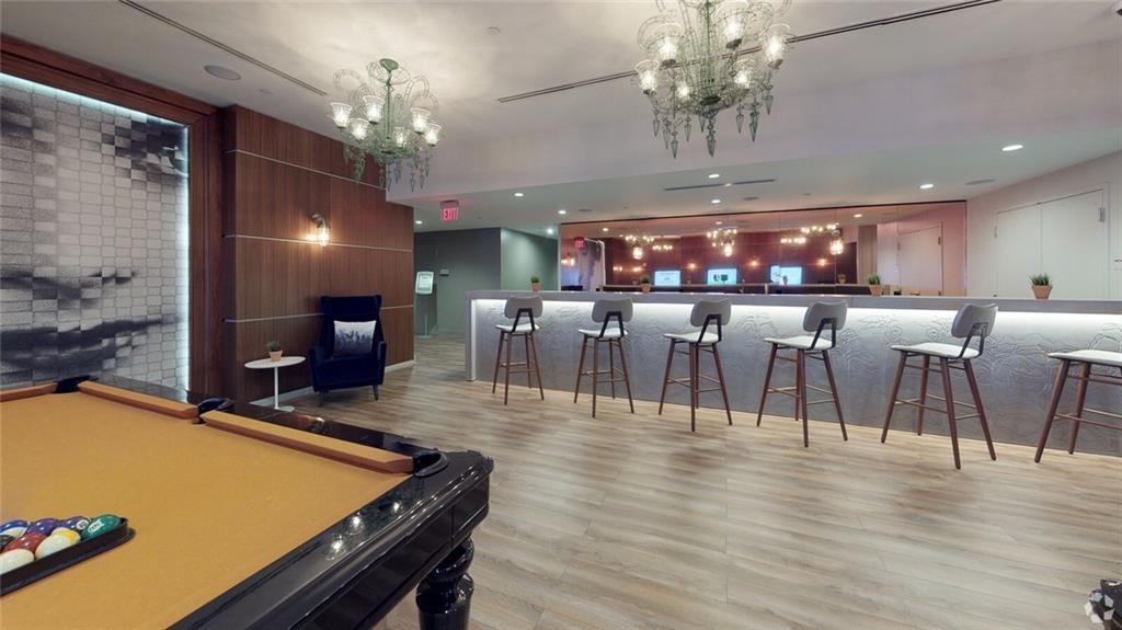 207 13th Street Northeast, Unit S2 Atlanta, GA 30309 - Photo 8 of 46 a view of a dining room with furniture a chandelier and wooden floor