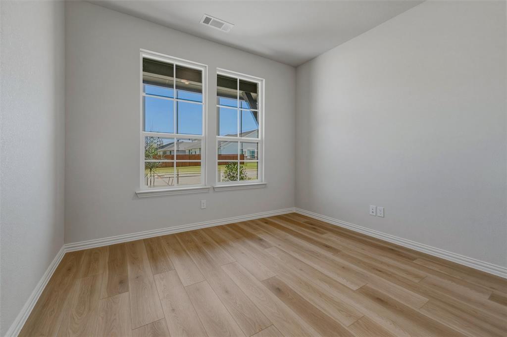 1337 Frio Drive Springtown, TX 76082 - Photo 15 of 40 Light-toned wood-finish flooring complements neutral wall paint
