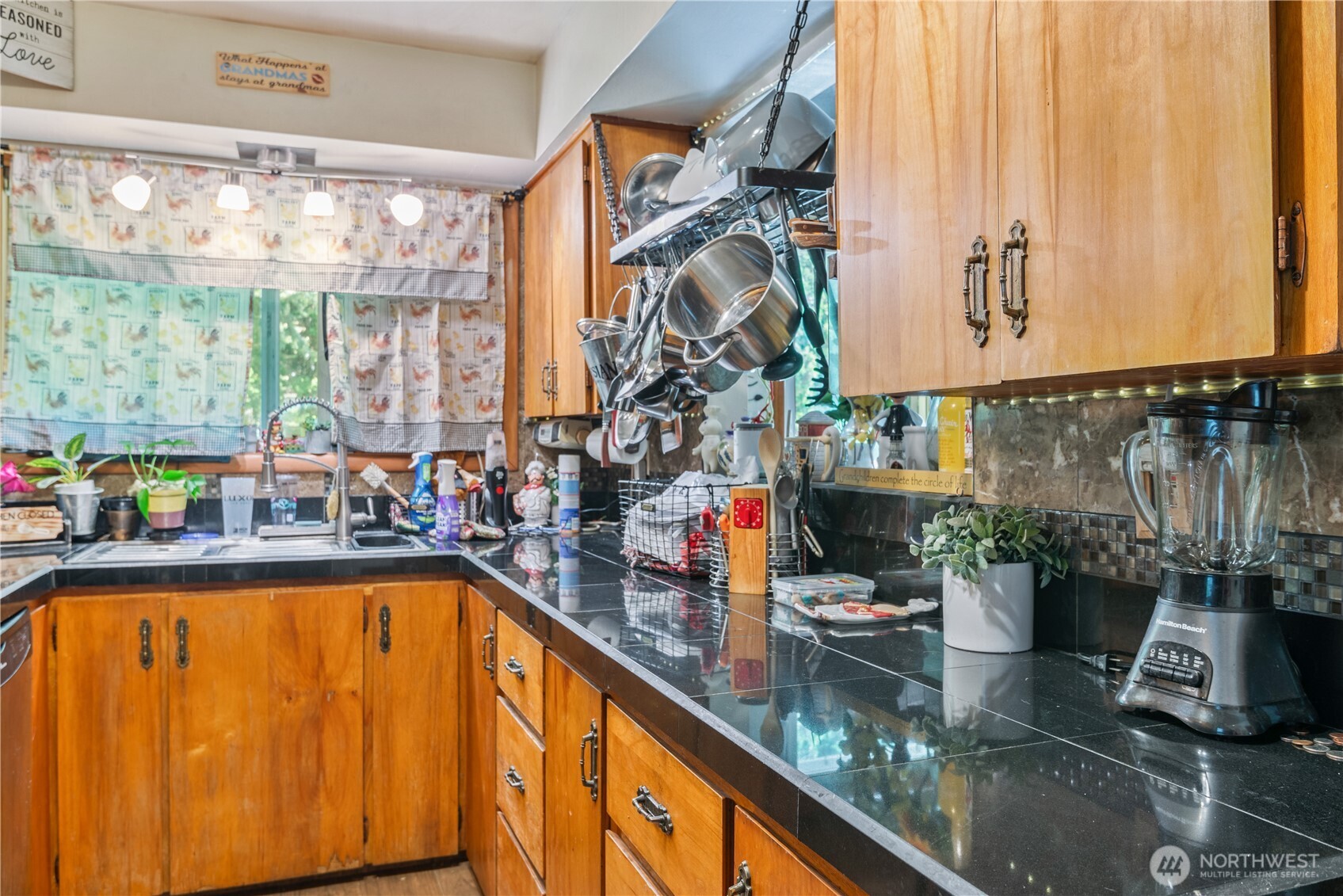 1016 Oak Street Kelso, WA 98626 - Photo 11 of 24 a view of a living room with a floor to ceiling window and potted plants