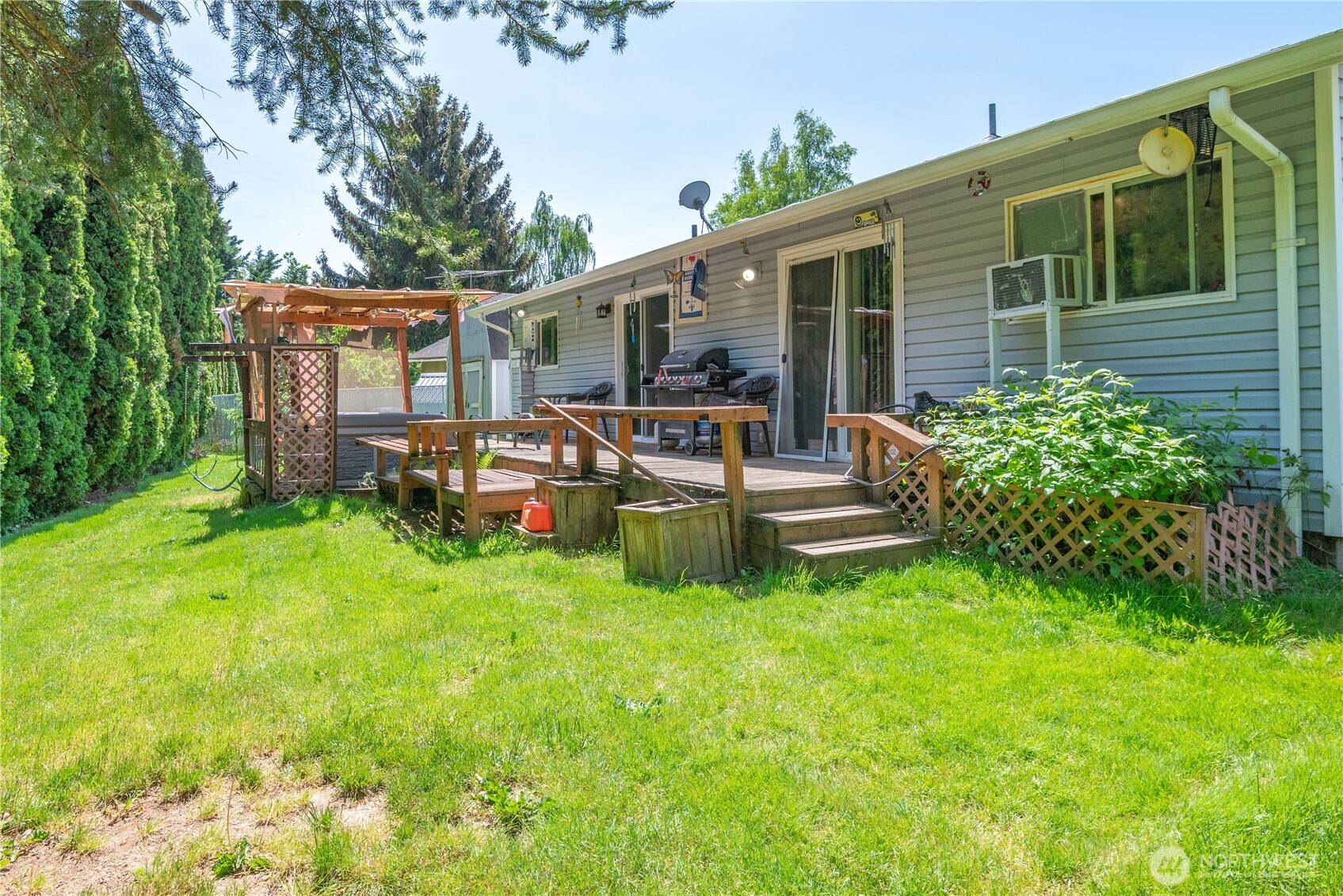1016 Oak Street Kelso, WA 98626 - Photo 21 of 24 a view of a house with backyard sitting area and garden