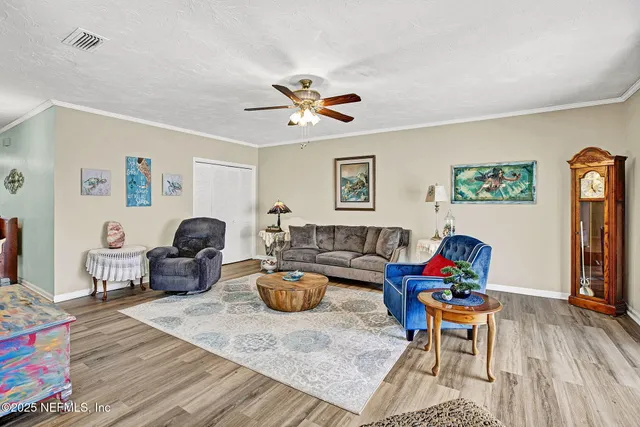 a living room with furniture a rug and a chandelier