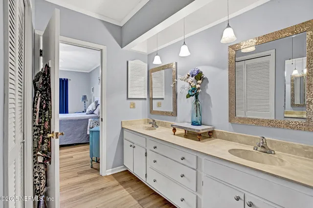 a bedroom with a large bed and a chandelier