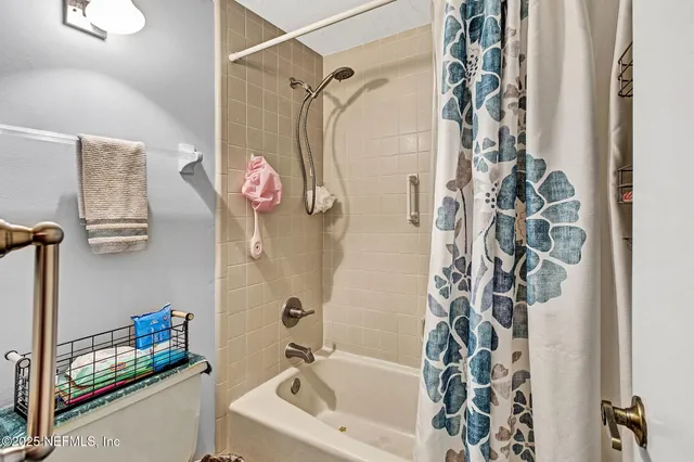 a bedroom with a bed and a bookshelf with wooden floor