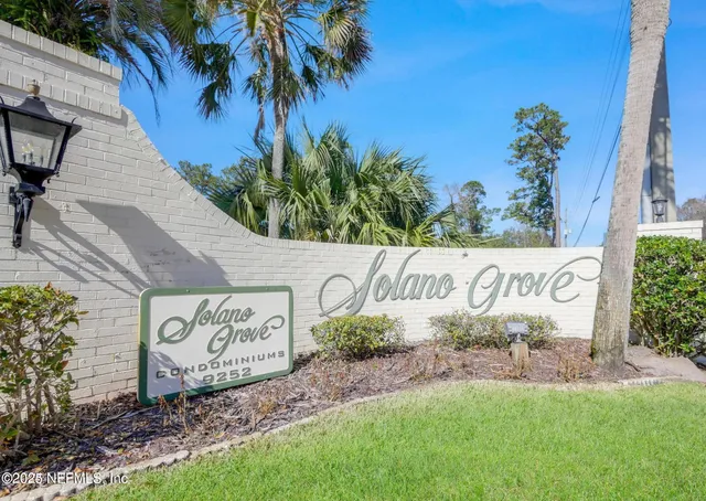 a view of a swimming pool with a patio and a yard