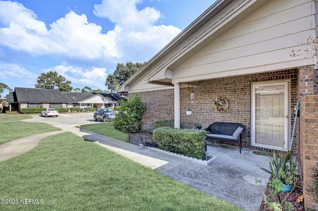 a view of a patio with table and chairs and potted plants