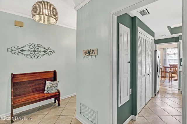 a kitchen with white cabinets and sink