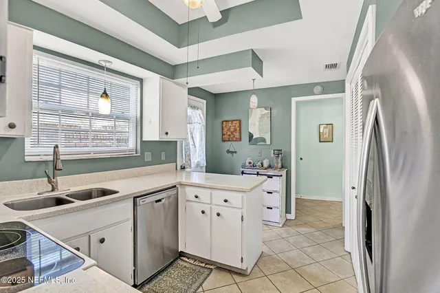 a kitchen with a stove a sink and a refrigerator