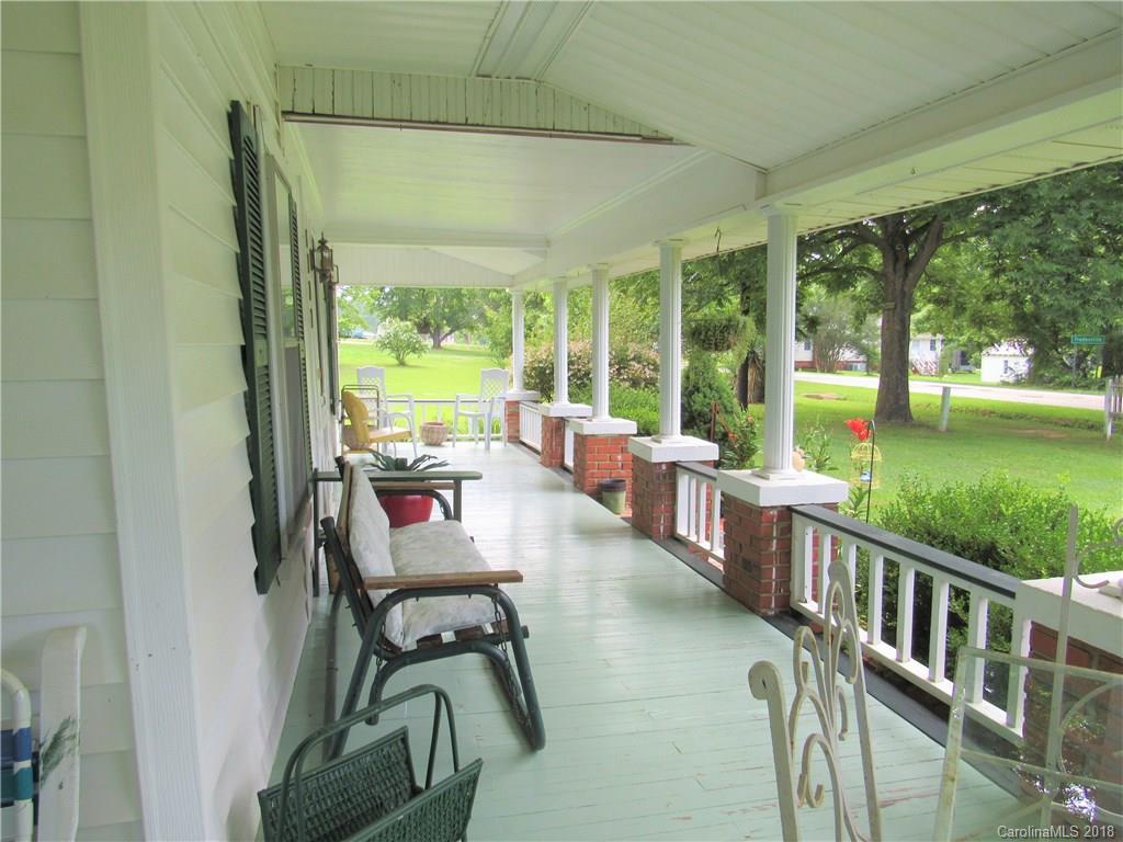 6737 Shiloh Unity Road Lancaster, SC 29720 - Photo 2 of 33 a view of a patio with chairs and floor to ceiling window