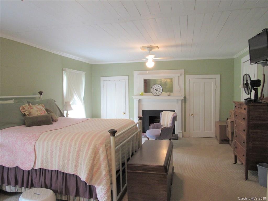 6737 Shiloh Unity Road Lancaster, SC 29720 - Photo 11 of 33 a bedroom with a bed and a fireplace