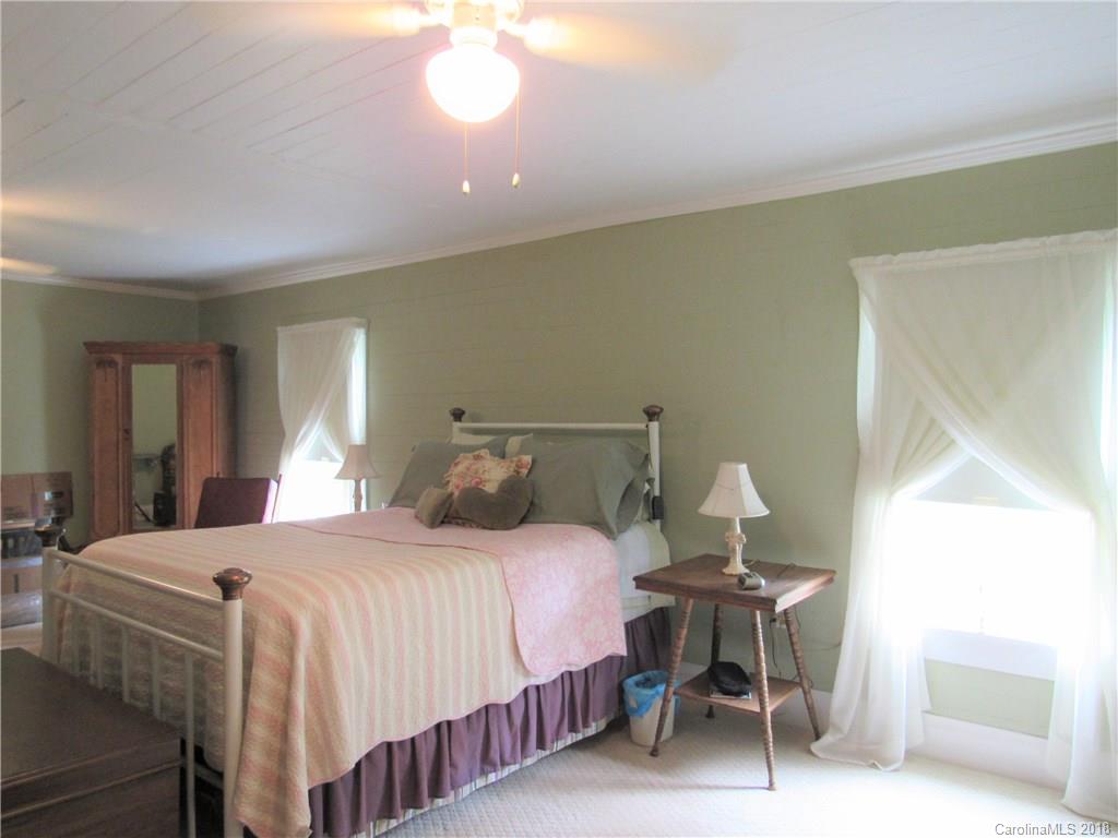 6737 Shiloh Unity Road Lancaster, SC 29720 - Photo 12 of 33 a bedroom with a bed and a chandelier