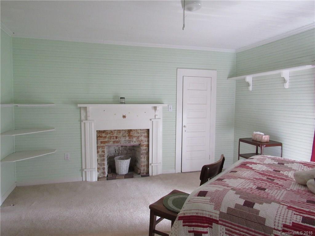 6737 Shiloh Unity Road Lancaster, SC 29720 - Photo 21 of 33 a bedroom with a bed and a fireplace