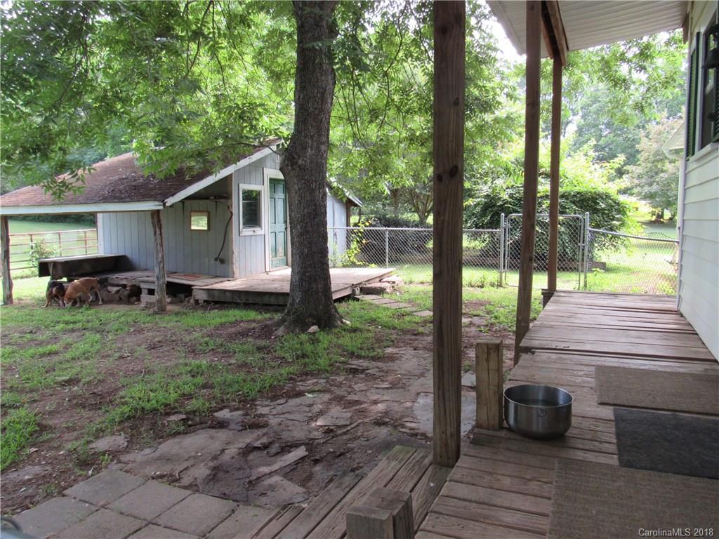 6737 Shiloh Unity Road Lancaster, SC 29720 - Photo 32 of 33 a view of a backyard with couches plants and large trees