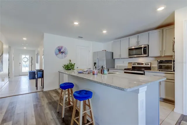 a kitchen with a sink a microwave and refrigerator