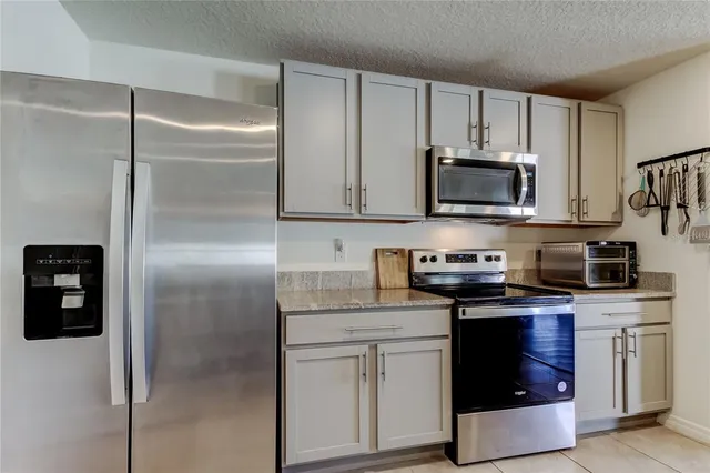 a kitchen with a refrigerator stove and microwave