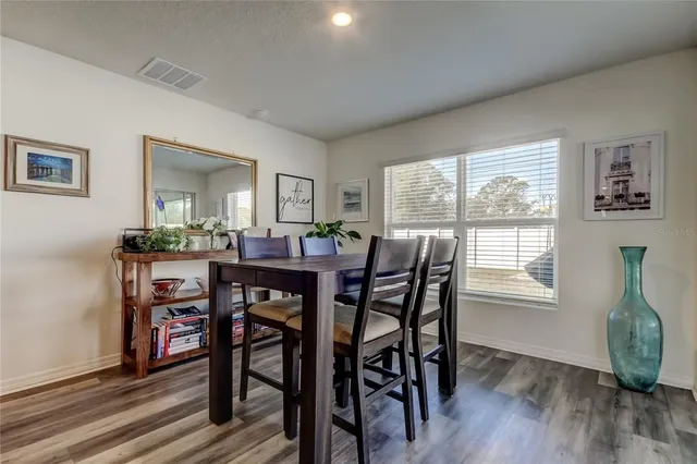 a view of a dining room with furniture window and wooden floor
