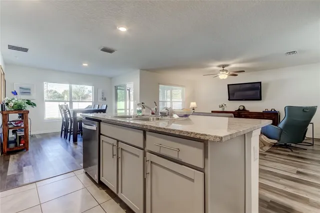 a kitchen with a sink cabinets and wooden floor