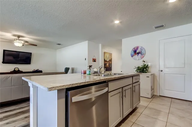 a living room with furniture and kitchen view