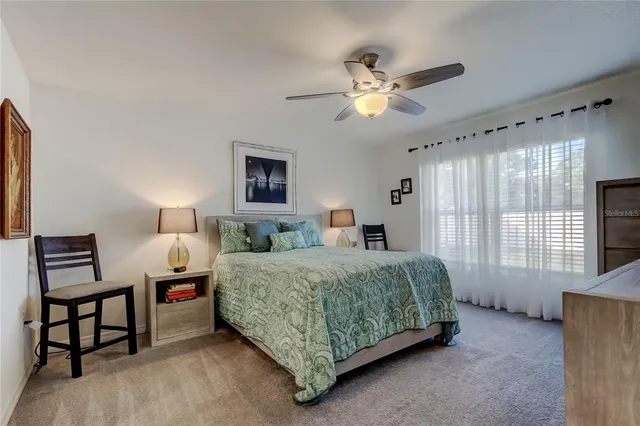 a bedroom with a large bed and a flat tv screen