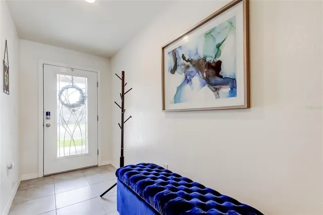 a bedroom with a bed and a painting on the wall
