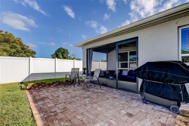 a view of a house with swimming pool and sitting area