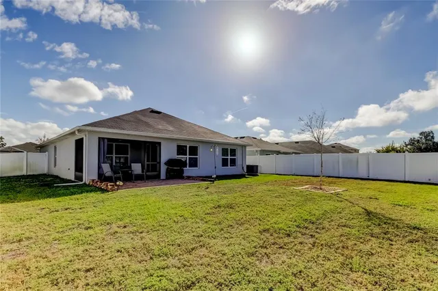 a view of yard with swimming pool and furniture