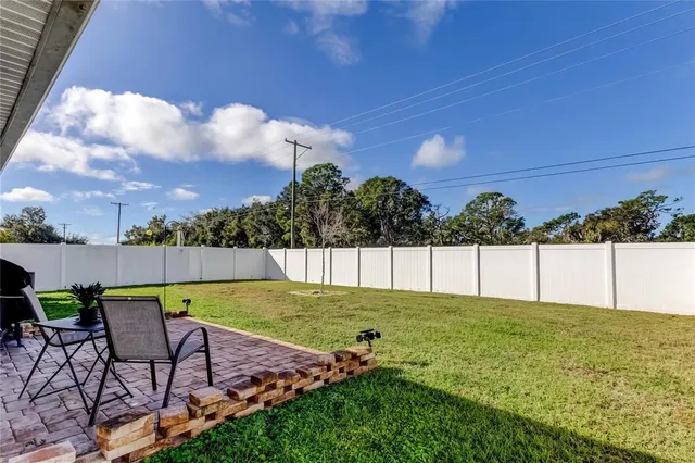 a view of yard with swimming pool and trees