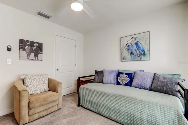 a blue white couch sitting next to a white walls