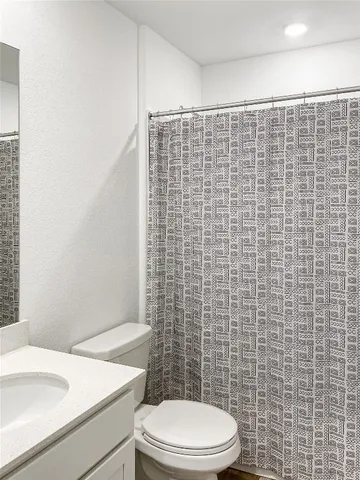 a white toilet sitting next to a bathroom sink