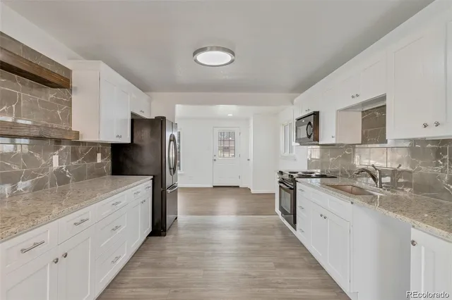 a kitchen with stainless steel appliances granite countertop a sink stove and refrigerator