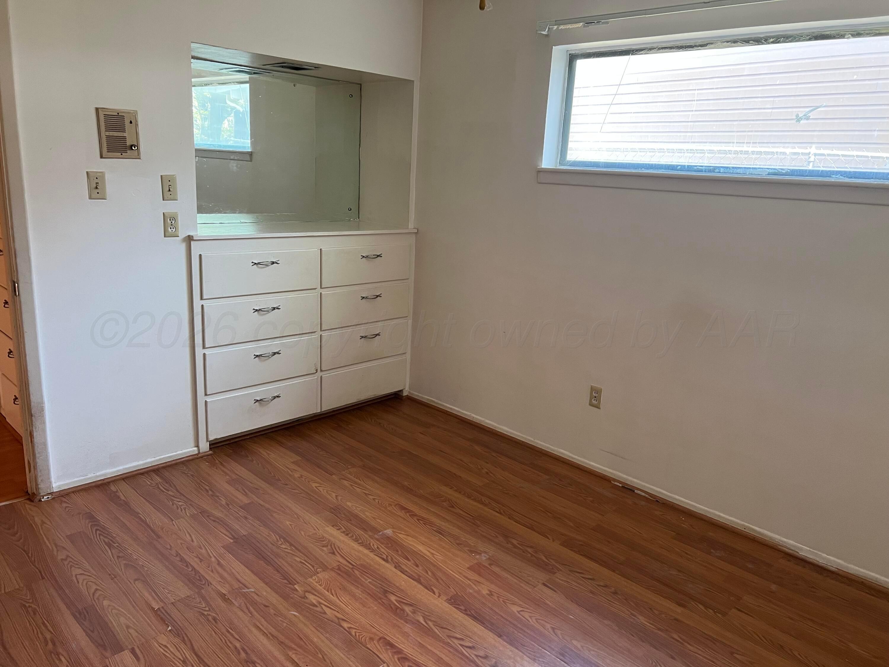 316 Poplar Street Amarillo, TX 79107 - Photo 4 of 8 a view of a room with wooden floor and cabinet