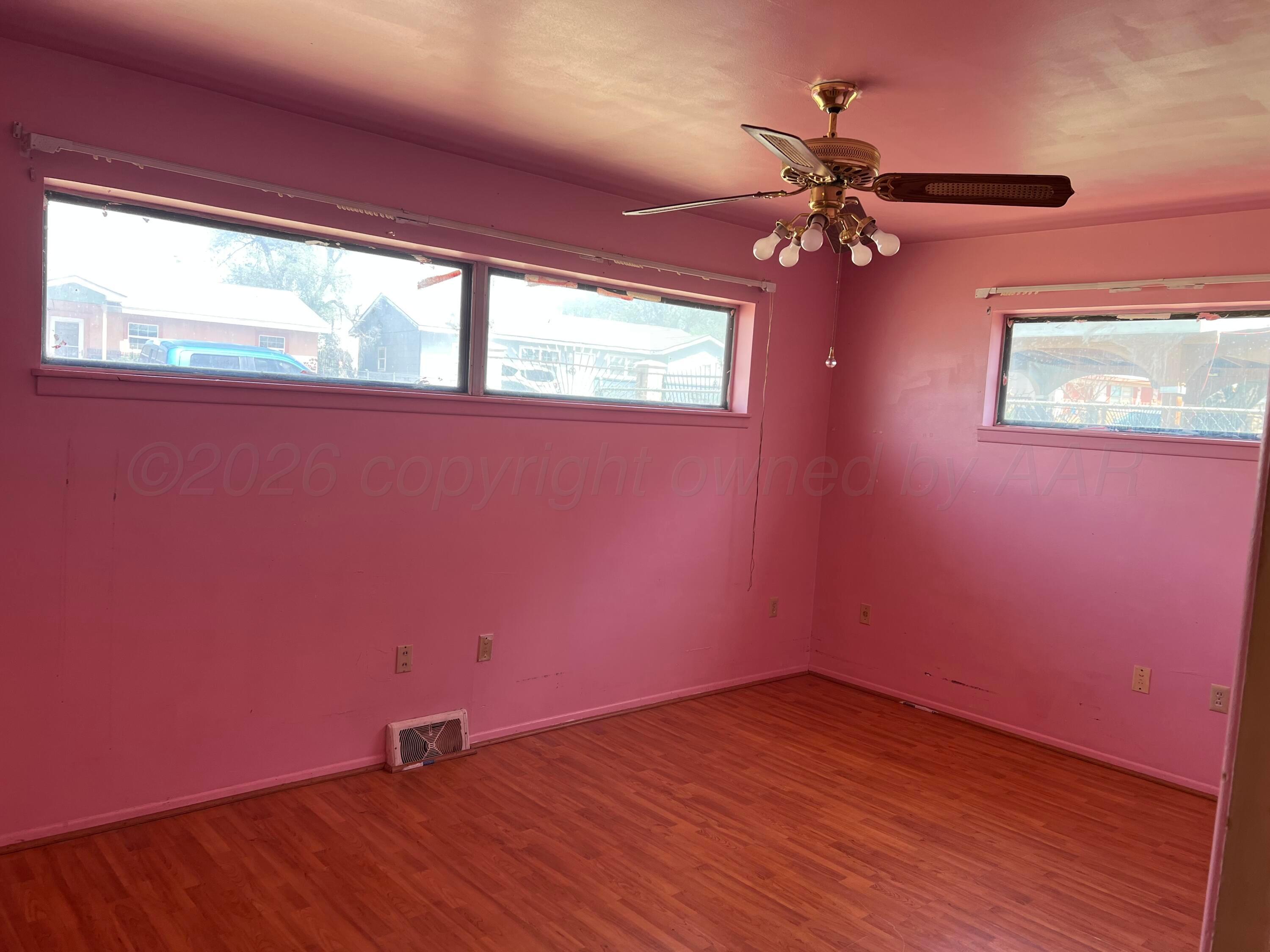 316 Poplar Street Amarillo, TX 79107 - Photo 5 of 8 a view of empty room with wooden floor and fan