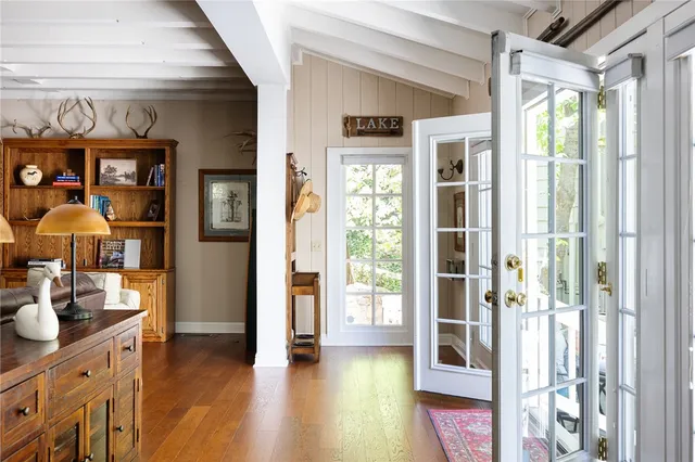 a view of hallway with furniture and wooden floor