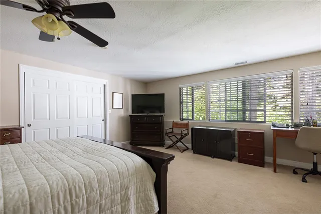 a bedroom with a bed furniture and a window