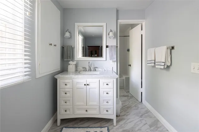 a bathroom with a double vanity sink a mirror and a shower