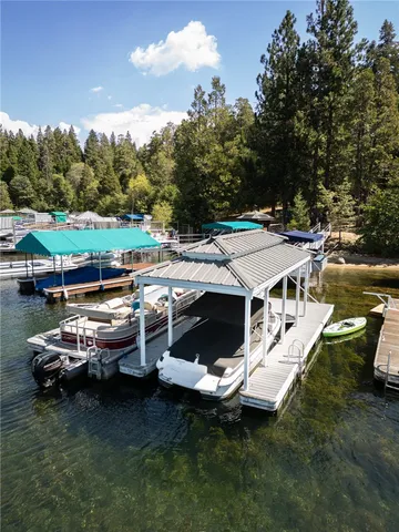a aerial view of a house with swimming pool and lake view