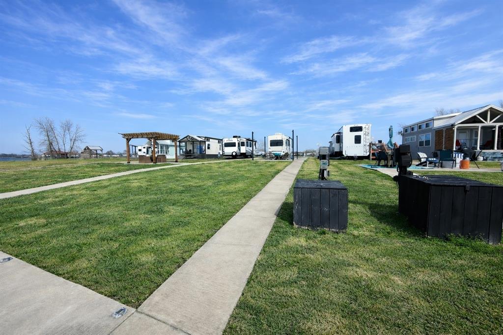6454 Peninsula Road Kerens, TX 75144 - Photo 21 of 40 a view of a garden with a building in the background