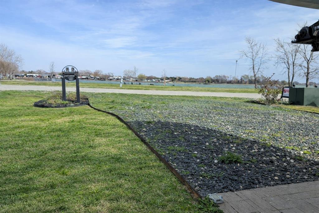 6454 Peninsula Road Kerens, TX 75144 - Photo 24 of 40 a view of a river and garden with trees in the background