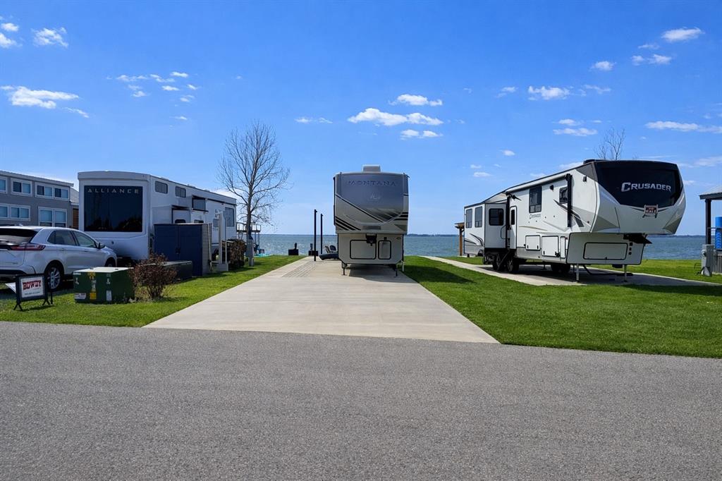 6454 Peninsula Road Kerens, TX 75144 - Photo 5 of 40 a front view of a house with a yard fire pit and outdoor seating