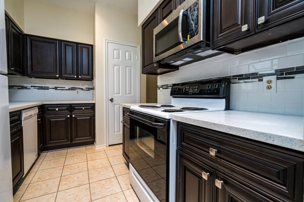 a kitchen with stainless steel appliances granite countertop a stove microwave and cabinets