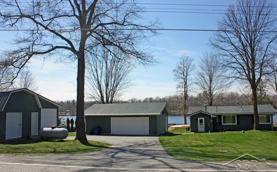 3072 South Whitney Beach Road Beaverton, MI 48612 - Photo 2 of 21 Overall view of the home, garage and out building from the paved road.