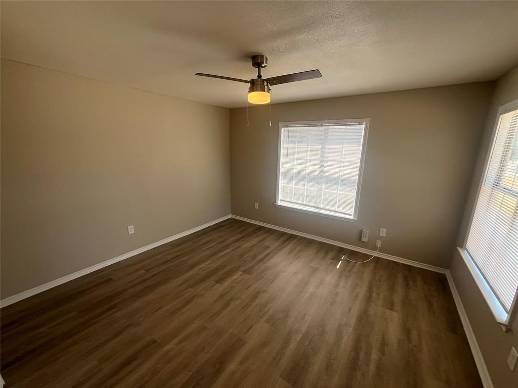 6814 Lockheed Avenue Dallas, TX 75209 - Photo 3 of 16 Wood-finish flooring, neutral wall color, ceiling fan, and multiple windows with blinds
