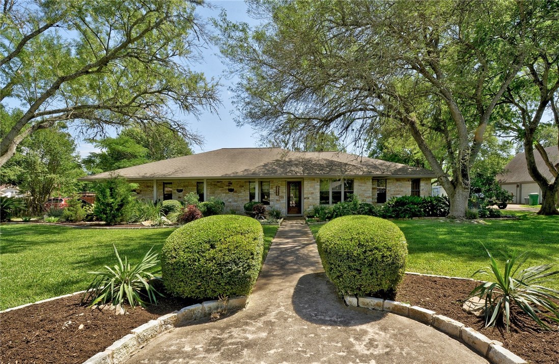 3511 Eldorado Trail Austin, TX 78739 - Photo 1 of 1 a view of a backyard with table and chairs under an umbrella