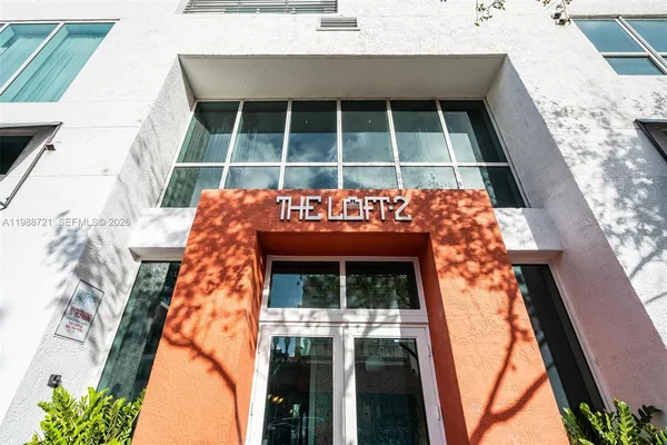 a view of a building with a street sign and a building