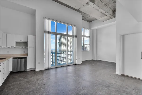 a living room with furniture and windows