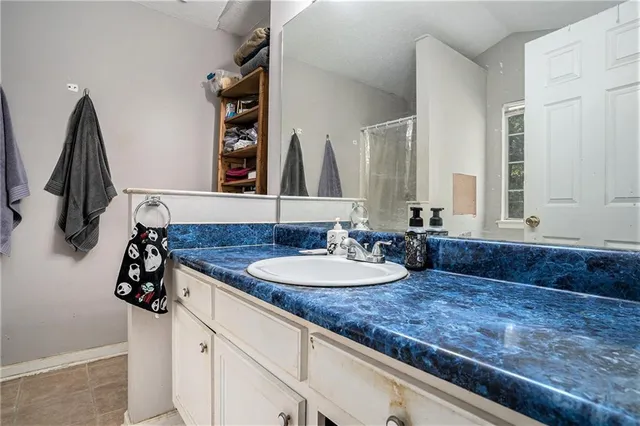 a white bath tub sitting in a bathroom next to a white sink