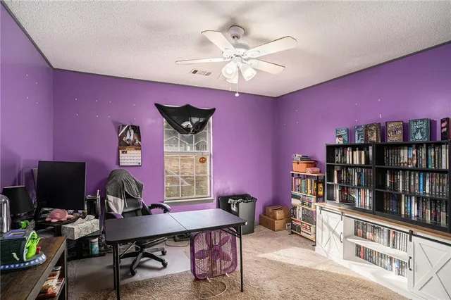 a view of a livingroom with workspace and a window