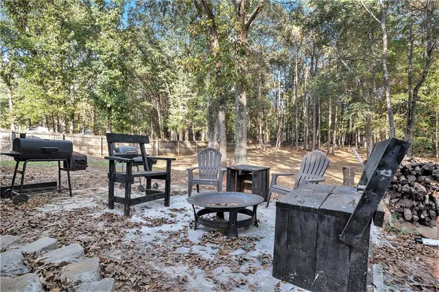 a front view of house with yard and trees in the background