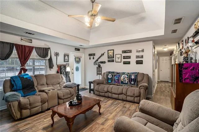 a living room with furniture and a chandelier